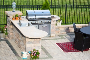 Stylish outdoor kitchen on a brick patio Stylish outdoor kitchen on a brick patio